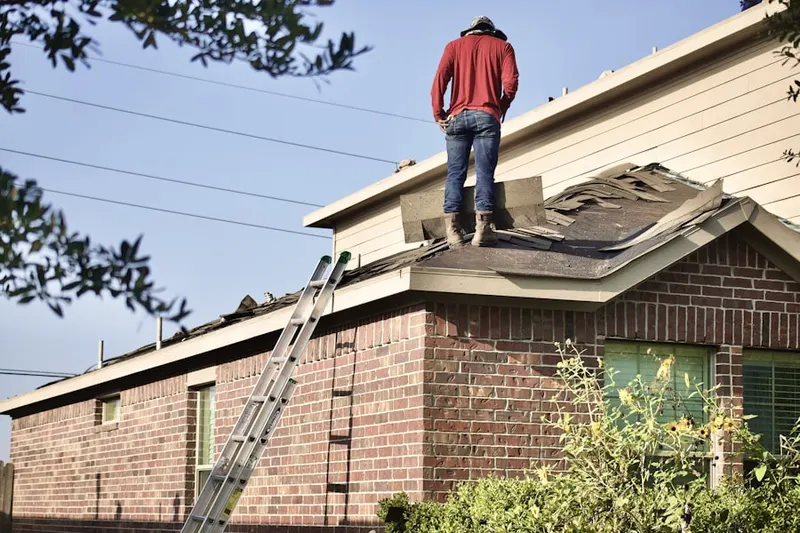 Professional roofer working on a residential roof in Gunpowder